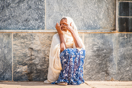 OMO, ETHIOPIA - SEPTEMBER 21, 2011: Unidentified Ethiopian women in a white tissues in the street. People in Ethiopia suffer of poverty due to the unstable situationのeditorial素材