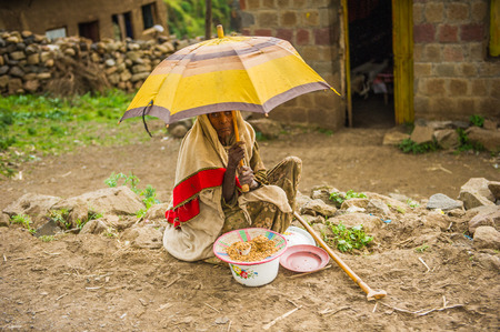 OMO, ETHIOPIA - SEPTEMBER 21, 2011: Unidentified Ethiopian woman under an umbrella in the street....