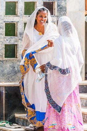 OMO, ETHIOPIA - SEPTEMBER 21, 2011: Unidentified Ethiopian women in a white tissues in the street. People in Ethiopia suffer of poverty due to the unstable situationのeditorial素材