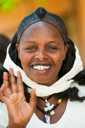AKSUM, ETHIOPIA - SEP 24, 2011: Unidentified Ethiopian beautiful girl wearing white tissue in Ethiopia, Sep.24, 2011. Children in Ethiopia suffer of poverty due to the unstable situationのeditorial素材
