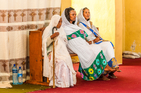 OMO, ETHIOPIA - SEPTEMBER 21, 2011: Unidentified Ethiopian women in a white tissues in the street. People in Ethiopia suffer of poverty due to the unstable situationのeditorial素材
