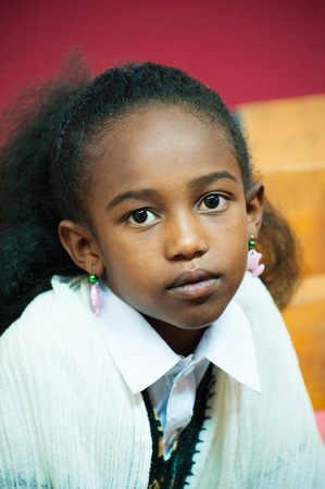 AKSUM, ETHIOPIA - SEP 24, 2011: Unidentified Ethiopian girl wearing wearing old clothes in Ethiopia, Sep.24, 2011. Children in Ethiopia suffer of poverty due to the unstable situationのeditorial素材