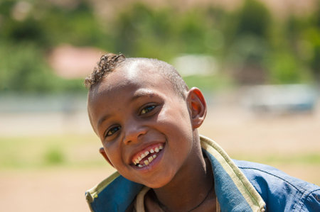 AKSUM, ETHIOPIA - SEP 24, 2011: Unidentified Ethiopian cute little boy with a funny haircut in Ethiopia, Sep.24, 2011. Children in Ethiopia suffer of poverty due to the unstable situationのeditorial素材
