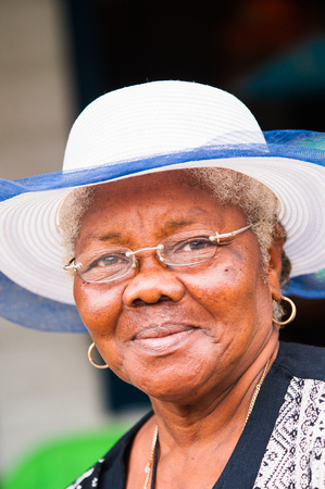 GUATEMALA CITY, GUATEMALA - JANUARY 3, 2012: Portrait of unidentified smiling old lady in a white hat in Guatemala. 59.4% of Guatemala people belong to the Mestizo ethnic groupのeditorial素材