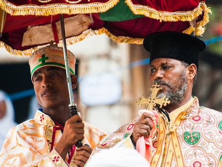 LALIBELA, ETHIOPIA - SEP 27, 2011: Unidentified Ethiopian priest holds the golden cross during the Meskel festival in Ehtiopia, Sep 27, 2011. Meskel commemorates the finding of the True Crossのeditorial素材