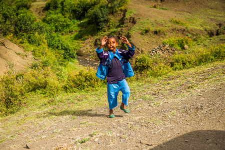 OMO, ETHIOPIA - SEPTEMBER 21, 2011: Unidentified Ethiopian boy runs. People in Ethiopia suffer of poverty due to the unstable situationのeditorial素材