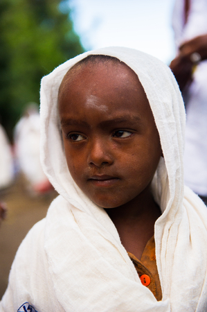 AKSUM, ETHIOPIA - SEP 27, 2011: Portrait of an unidentified Ethiopian boy in white tissue in Ethiopia, Sep.27, 2011. Children in Ethiopia suffer of poverty due to the unstable situationのeditorial素材