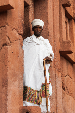 LALIBELA, ETHIOPIA - SEPTEMBER 27, 2011: Unidentified Ethiopian religious man near the Lalibela church cut off the rock. People in Ethiopia suffer of poverty due to the unstable situation.のeditorial素材