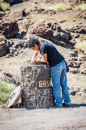 MANAGUA, NICARAGUA - JAN 6, 2012: Unidentified Nicaraguan man checks out the garbage. 69% of Nicaranguan people belong to the Mestizo ethnic groupのeditorial素材
