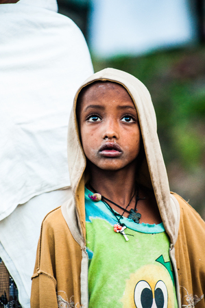 LALIBELA, ETHIOPIA - SEPTEMBER 27, 2011: Unidentified Ethiopian little sad girl. People in Ethiopia suffer of poverty due to the unstable situationのeditorial素材