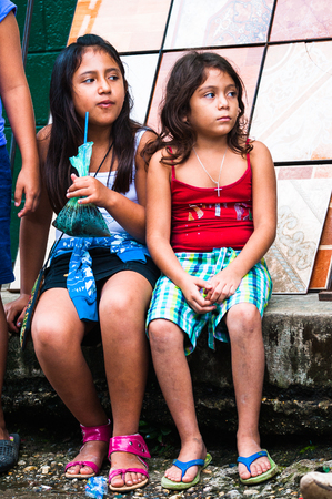 GUATEMALA CITY, GUATEMALA - JANUARY 3, 2012: Portrait of two unidentified beautiful girls playing outdoors in Guatemala. 59.4% of Guatemala people belong to the Mestizo ethnic groupのeditorial素材