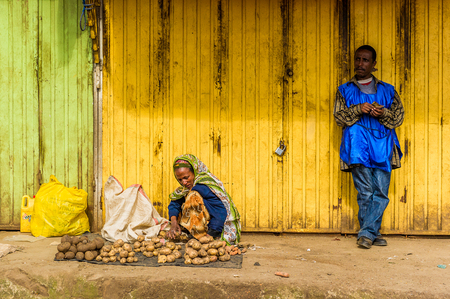 OMO, ETHIOPIA - SEPTEMBER 21, 2011: Unidentified Ethiopian woman sells potatoes. People in Ethiopia suffer of poverty due to the unstable situationのeditorial素材