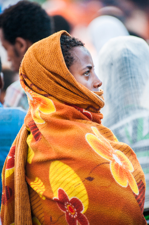 LALIBELA, ETHIOPIA - SEPTEMBER 28, 2011: Unidentified Ethiopian woman wears a tissue. People in Ethiopia suffer of poverty due to the unstable situationのeditorial素材