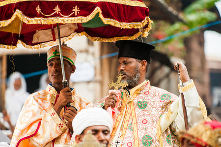 LALIBELA, ETHIOPIA - SEP 27, 2011: Unidentified Ethiopian priest holds the golden cross during the...
