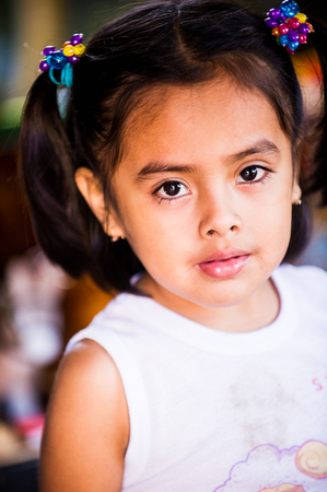 MANAGUA, NICARAGUA - JAN 6, 2012: Unidentified Nicaraguan little girl with pigtail. 69% of Nicaranguan people belong to the Mestizo ethnic groupのeditorial素材