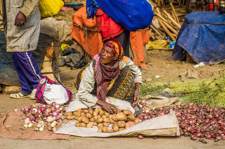 OMO, ETHIOPIA - SEPTEMBER 21, 2011: Unidentified Ethiopian woman sells potatoes. People in Ethiopia suffer of poverty due to the unstable situationのeditorial素材