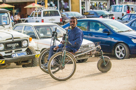 OMO, ETHIOPIA - SEPTEMBER 21, 2011: Unidentified Ethiopian man in a bycicle in the street. People in...