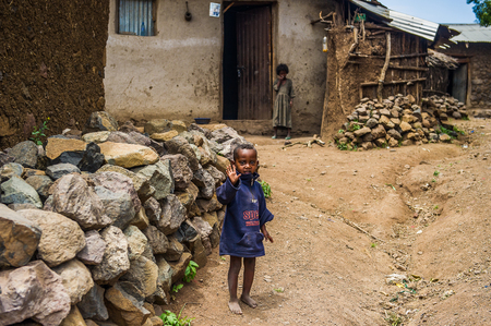 OMO, ETHIOPIA - SEPTEMBER 21, 2011: Unidentified Ethiopian girl near a house. People in Ethiopia suffer of poverty due to the unstable situationのeditorial素材