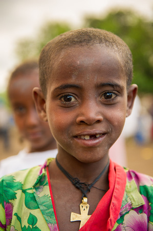 AKSUM, ETHIOPIA - SEP 27, 2011: Portrait of an unidentified Ethiopian cute girl without a tooth in Ethiopia, Sep.27, 2011. Children in Ethiopia suffer of poverty due to the unstable situationのeditorial素材