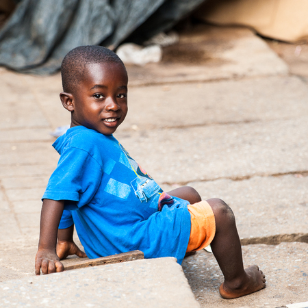 ACCRA, GHANA - MARCH 4, 2012: Unidentified Ghanaian boy in the street in Ghana. Children of Ghana suffer of poverty due to the unstable economic situationのeditorial素材