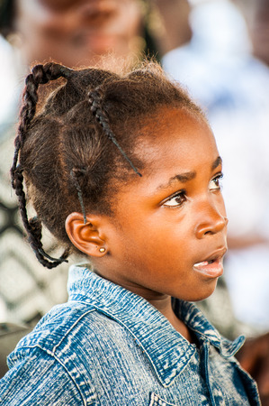 ACCRA, GHANA - MARCH 4, 2012: Unidentified Ghanaian beautiful girl portrait in the street in Ghana. People of Ghana suffer of poverty due to the unstable economic situationのeditorial素材