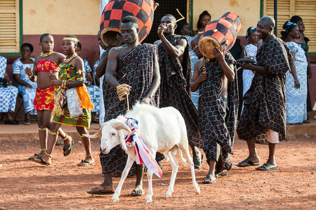 ACCRA, GHANA - MARCH 4, 2012: Unidentified Ghanaian man makes a performence with a goat in Ghana....