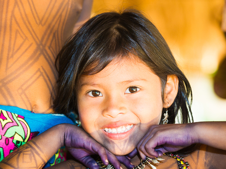 EMBERA VILLAGE, PANAMA, JANUARY 9, 2012: Portrait of an unidentified native Indian girl smiling for the camera in Panama, Jan 9, 2012. Indian reservation is the way to conserve native cultureのeditorial素材