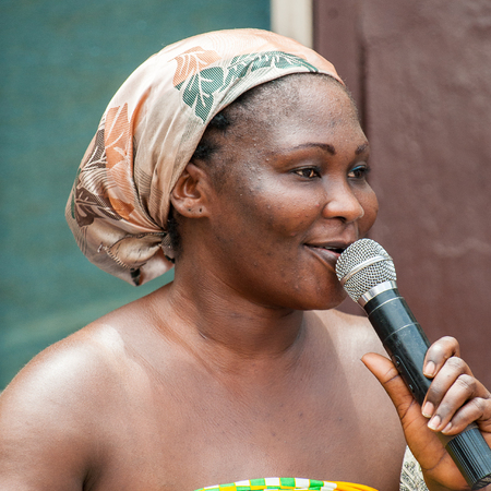 ACCRA, GHANA - MARCH 4, 2012: Unidentified Ghanaian woman sings a song at the local street music show in Ghana. Music is the main kind of entertainment in Africaのeditorial素材