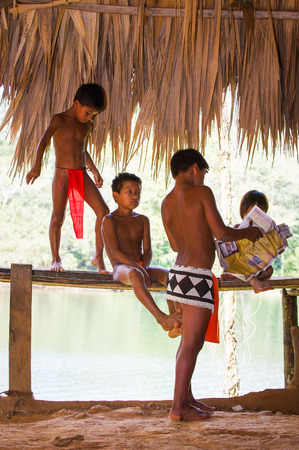 EMBERA VILLAGE, PANAMA, JANUARY 9, 2012: Unidentified native Indian children in a cabin of Indian reservation in Panama, Jan 9, 2012. Indian reservation is the way to conserve native cultureのeditorial素材