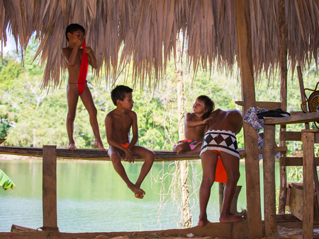 EMBERA VILLAGE, PANAMA, JANUARY 9, 2012: Unidentified native Indian children in a cabin of Indian reservation in Panama, Jan 9, 2012. Indian reservation is the way to conserve native cultureのeditorial素材