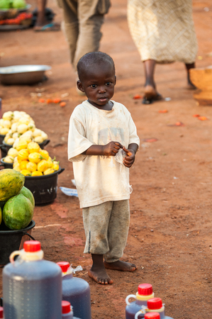 ACCRA, GHANA - MARCH 5, 2012: Unidentified Ghanaian boy at the market in the street in Ghana. Children of Ghana suffer of poverty due to the unstable economic situationのeditorial素材