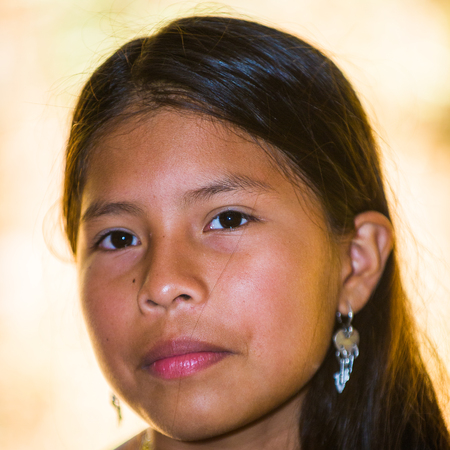 EMBERA VILLAGE, PANAMA, JANUARY 9, 2012: Portrait of an unidentified native Indian girl wearing a blue dress in Panama, Jan 9, 2012. Embera village is the Indian reservation in Panamaのeditorial素材