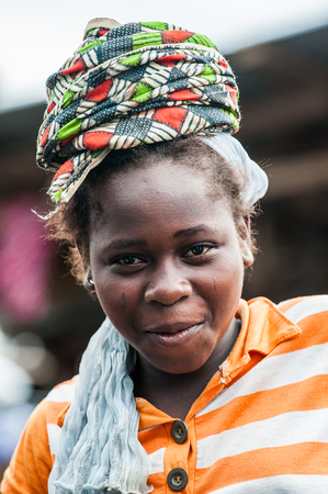 ACCRA, GHANA - MARCH 4, 2012: Unidentified Ghanaian woman portrait in Ghana. People of Ghana suffer of poverty due to the unstable economic situationのeditorial素材