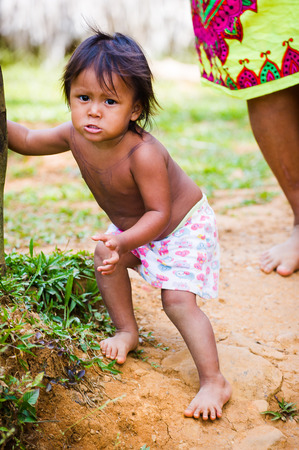 EMBERA VILLAGE, PANAMA, JANUARY 9, 2012: Portrait of a native Indian little playing in the jungle in Panama, Jan 9, 2012. Indian reservation is the way to conserve native cultureのeditorial素材