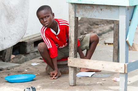 ACCRA, GHANA - MARCH 2, 2012: Unidentified Ghanaian boy in a Liverpool FC football shirt in the...