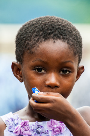 ACCRA, GHANA - MARCH 4, 2012: Unidentified Ghanaian beautiful girl in a dress portrait in Ghana. People of Ghana suffer of poverty due to the unstable economic situationのeditorial素材