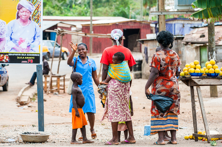 ACCRA, GHANA - MARCH 2, 2012: Unidentified Ghanaian women with their children in the street in...