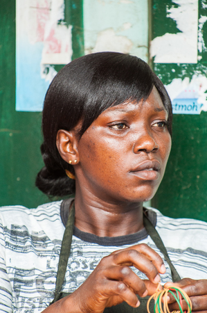 ACCRA, GHANA - MARCH 4, 2012: Unidentified Ghanaian woman portrait in Ghana. People of Ghana suffer of poverty due to the unstable economic situationのeditorial素材
