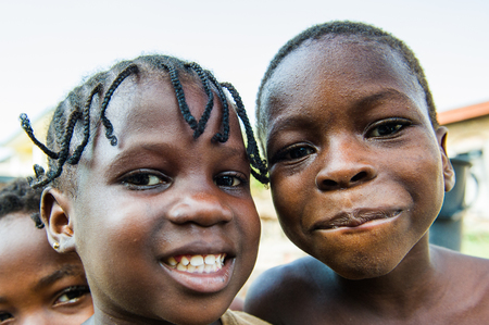 GHANA - MARCH 2, 2012: Two unindentified Ghanaian girls pose for the camera in Ghana, on March 2nd, 2012. People in Ghana suffer from poverty due to the slow development of the countryのeditorial素材