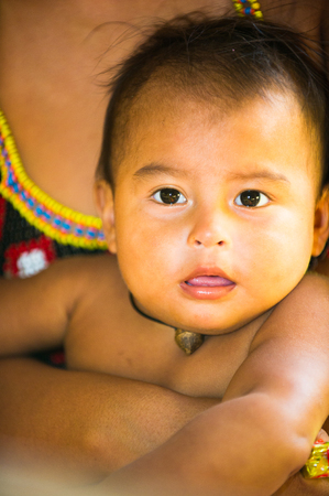 EMBERA VILLAGE, PANAMA, JANUARY 9, 2012: Portrait of an unidentified native Indian baby boy  in Panama, Jan 9, 2012. Indian reservation is the way to conserve native culture, languange, traditionsのeditorial素材
