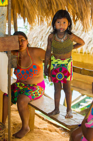 EMBERA VILLAGE, PANAMA, JANUARY 9, 2012: Unidentified native Indian children in a cabin of Indian reservation in Panama, Jan 9, 2012. Indian reservation is the way to conserve native cultureのeditorial素材