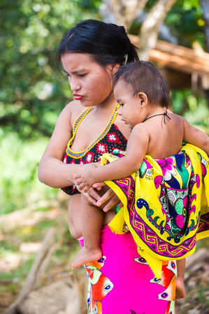 EMBERA VILLAGE, PANAMA, JANUARY 9, 2012: Portrait of an unidentified native Indian baby boy on his mother arms in Panama, Jan 9, 2012. Embera village is the Indian reservation in Panamaのeditorial素材