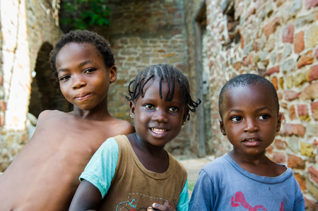 GHANA - MARCH 2, 2012: Three unindentified Ghanaian children smile for the camera in Ghana, on March 2nd, 2012. People in Ghana suffer from poverty due to the slow development of the countryのeditorial素材
