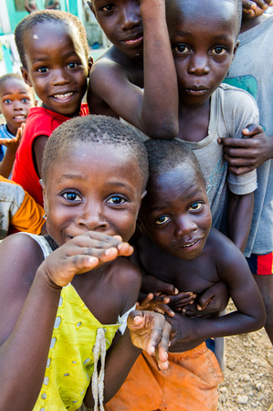 ACCRA, GHANA - MARCH 3, 2012: Unidentified Ghanaian children have fun and smile for the camera in Ghana. People of Ghana suffer of poverty due to the unstable economic situationのeditorial素材