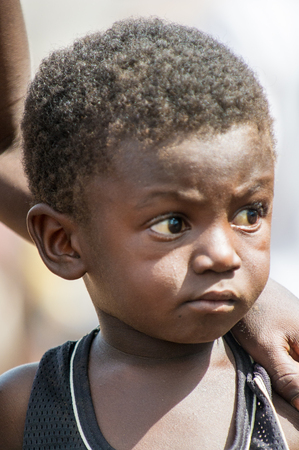ACCRA, GHANA - MARCH 6, 2012: Unidentified Ghanaian little boy in the street in Ghana. Children of Ghana suffer of poverty due to the unstable economic situationのeditorial素材