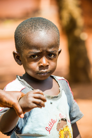 ACCRA, GHANA - MARCH 5, 2012: Unidentified Ghanaian boy in the street in Ghana. Children of Ghana suffer of poverty due to the unstable economic situationのeditorial素材