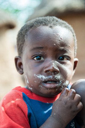 ACCRA, GHANA - MARCH 6, 2012: Unidentified Ghanaian boy in the street in Ghana. Children of Ghana suffer of poverty due to the unstable economic situationのeditorial素材