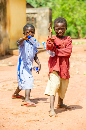 ACCRA, GHANA - MARCH 5, 2012: Unidentified Ghanaian boy smiles in the street in Ghana. Children of Ghana suffer of poverty due to the unstable economic situationのeditorial素材