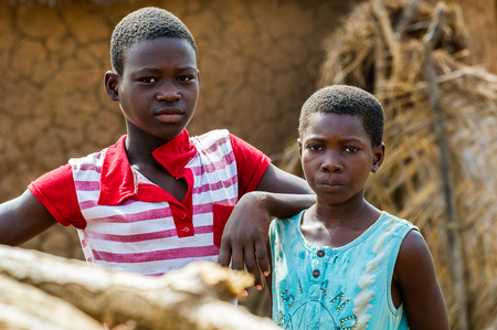 ACCRA, GHANA - MARCH 6, 2012: Unidentified Ghanaian boy and his sister in the street in Ghana. Children of Ghana suffer of poverty due to the unstable economic situationのeditorial素材