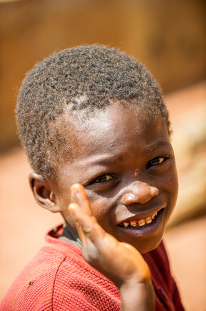 ACCRA, GHANA - MARCH 5, 2012: Unidentified Ghanaian boy smiles in the street in Ghana. Children of Ghana suffer of poverty due to the unstable economic situationのeditorial素材
